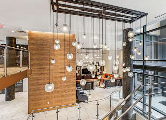 A modern interior with a wooden partition and hanging lights at The Maxwell Apartments, Arlington