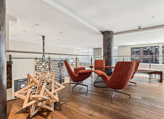 A room with a wooden floor and a white ceiling with a star-shaped object on the floor at The Maxwell Apartments, Arlington