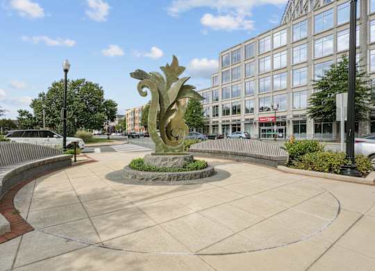 A dragon statue is in the middle of a plaza.