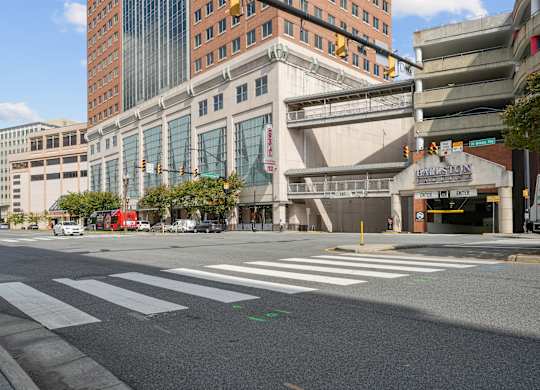 A city street with a crosswalk and a building with a sign that says