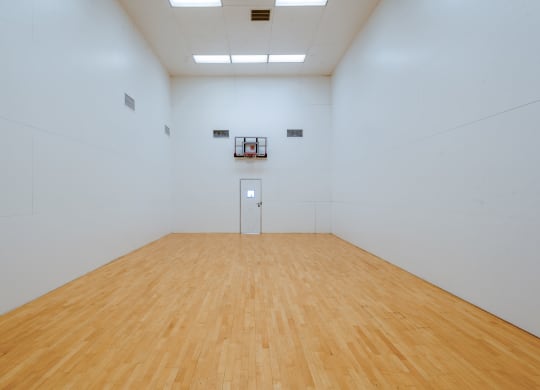 a large white room with a wooden floor and a white wall