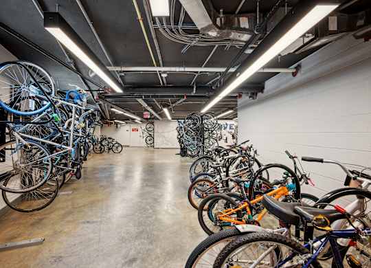 A bike rack full of bikes in a room.