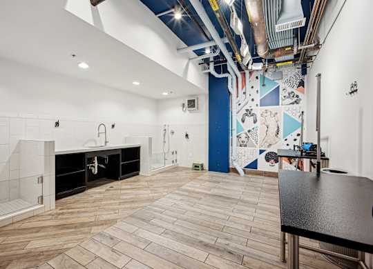 A room with a wooden floor and a mural on the wall.