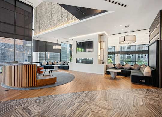 A modern living room with a curved wooden bench and a television.