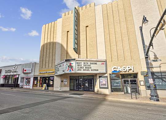 A street view of a building with a sign that reads