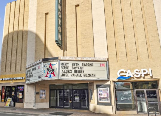The exterior of a cinema with a blue sky in the background.