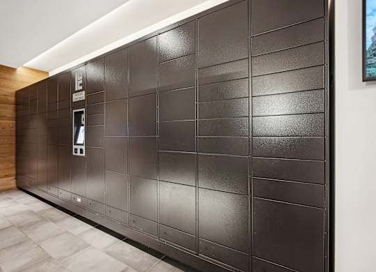 A wall of black tiles with a white light strip running along the top.