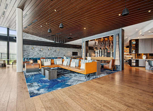 A modern interior with a wooden floor and a pool table.