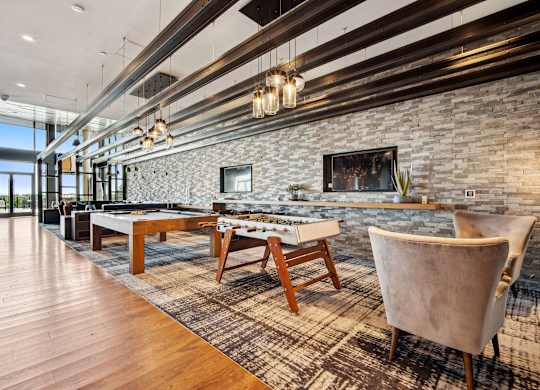 A room with a stone wall and a pool table.