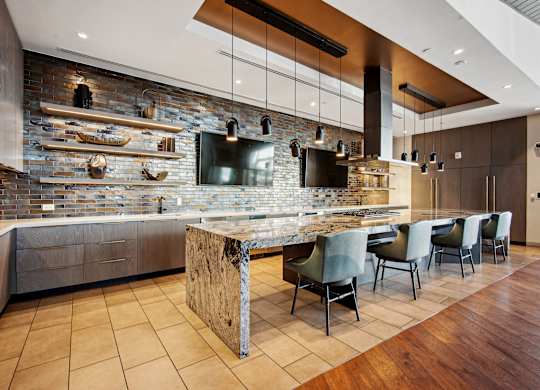A modern kitchen with a stone backsplash and a central island.