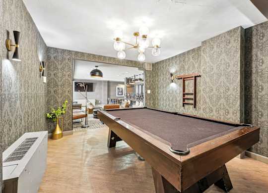 A pool table is in the middle of a room with a vintage feel at Wellington Apartments, Arlington, Virginia