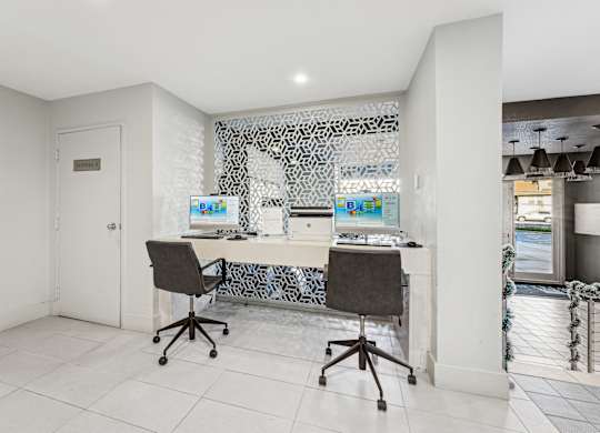A white room with a desk and chairs.