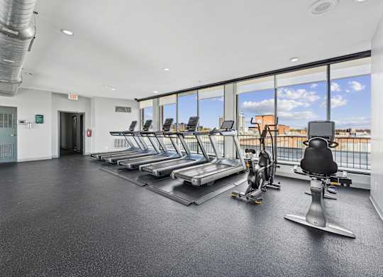 A gym with treadmills and exercise bikes at Wellington Apartments, Arlington, Virginia