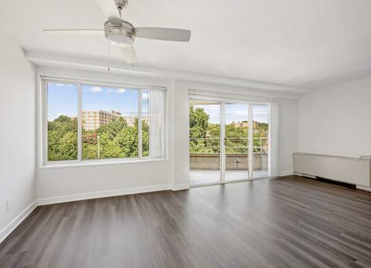 A room with a ceiling fan and sliding glass doors at Wellington Apartments, Arlington, Virginia