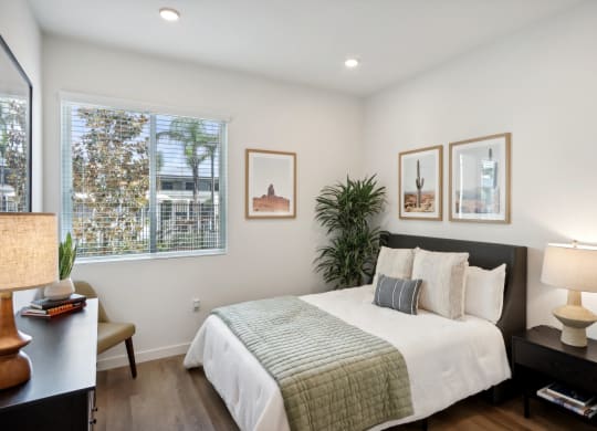 a bedroom with a bed and a window at The Max on Jefferson Apartments, Murrieta, CA, 92562