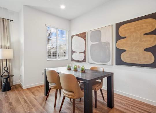 A dining room with a table and chairs at The Max on Jefferson Apartments, Murrieta, CA