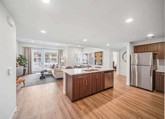 A modern kitchen with wooden floors and stainless steel appliances. at The Max on Jefferson Apartments, Murrieta, CA, 92562