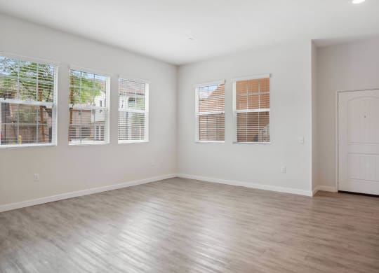 a bedroom with hardwood floors and white walls at Rancho Belago, Moreno Valley, CA