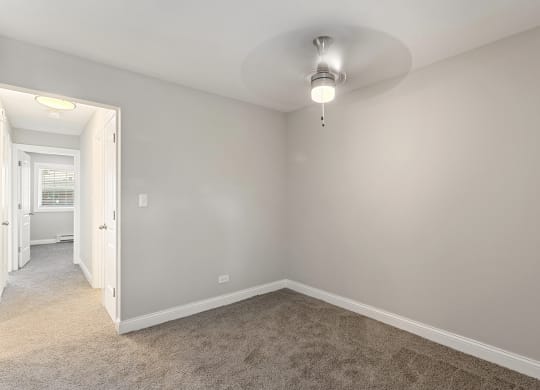 a bedroom with gray walls and carpet at The Hinsdale, Illinois