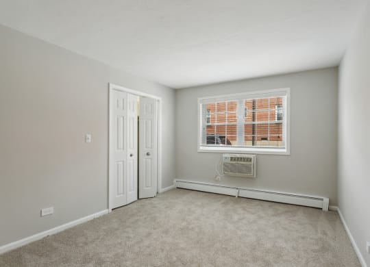 a bedroom with grey walls and carpet at The Hinsdale, Hinsdale, 60521