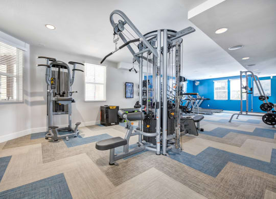 a workout room with a variety of exercise equipment