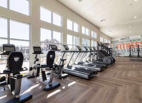 a gym with cardio machines and windows with a view of the city at Arrive Paso Robles, California, 93446