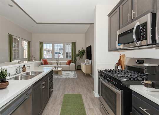 A modern kitchen with a stove top oven and a microwave above the counter.