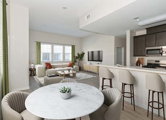 A modern living room with a white marble table and beige chairs.