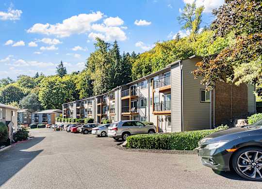 Apartment exteriors with a parking area and trees
