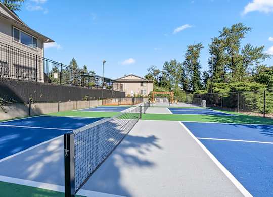 A tennis court with a blue and green surface and white lines.
