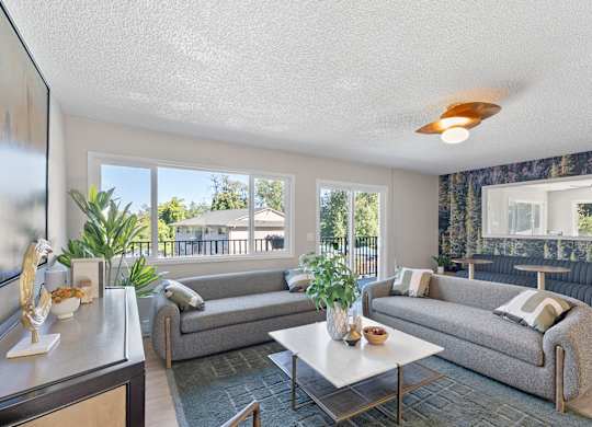 A living room with two grey couches and a coffee table.