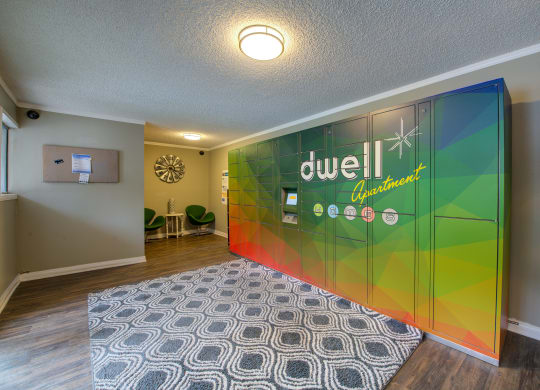 a room with a rug and a large sign on the wall at Dwell Apartment Homes, Riverside, CA