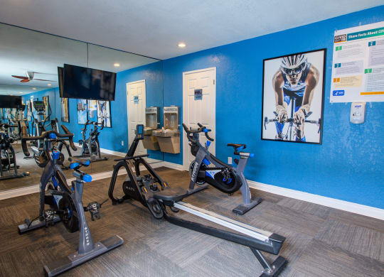 the gym at the enclave at woodbridge apartments in sugar land, tx at Dwell Apartment Homes, Riverside, California