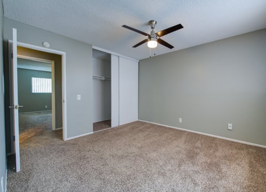 an empty bedroom with a ceiling fan at Dwell Apartment Homes, Riverside, CA, 92507