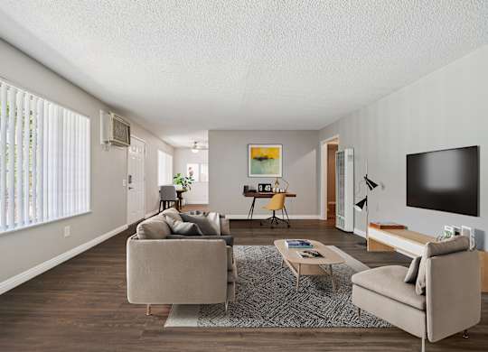 A living room with a couch, chair, and television.