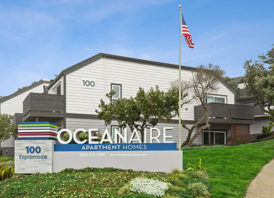 Oceanaire monument sign with apartment in background  at OceanAire Apartment Homes, Pacifica