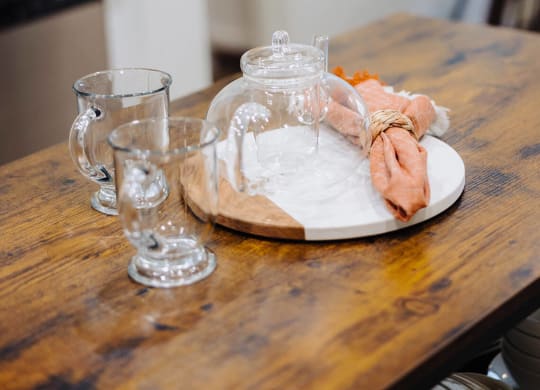 a wooden table with a plate and glasses on it at Arrive Paso Robles, California