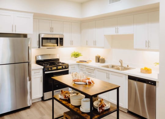 a kitchen with white cabinets and stainless steel appliances at Arrive Paso Robles, Paso Robles