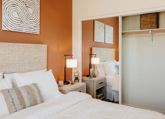 a bedroom with orange walls and white bedding at Arrive Paso Robles, California, 93446