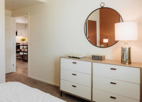 a bedroom with white walls and a white dresser with a mirror at Arrive Paso Robles, Paso Robles, CA