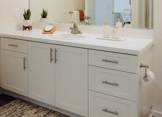 a bathroom with white cabinets and a large mirror  at Arrive Paso Robles, Paso Robles, 93446