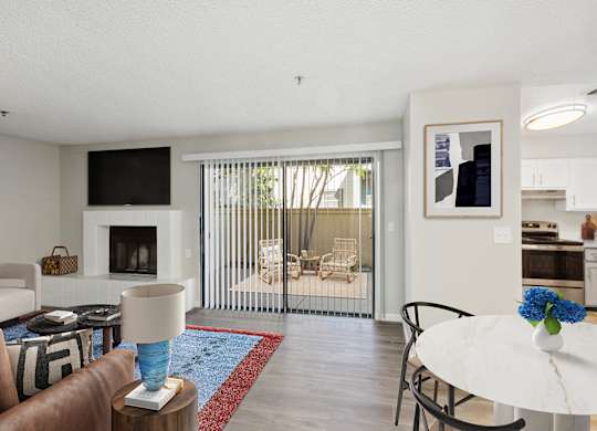 A living room with a white couch and a fireplace.