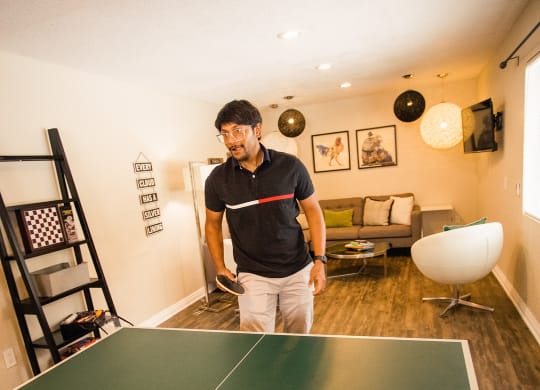 man playing ping pong at the clubhouse