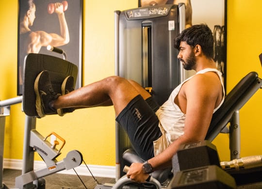 a man working out on a reformer exercise machine in a gym