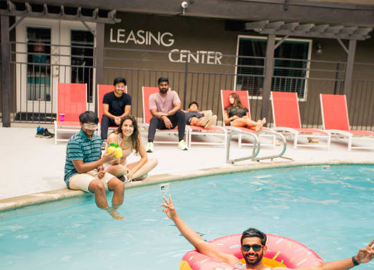 a man swimming in a pool with a floatie at Dwell
