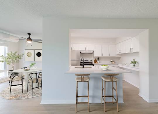 View of the kitchen with a bar area and a dining table.