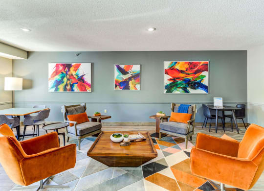 a living room with orange chairs and a coffee table on a checkered floor