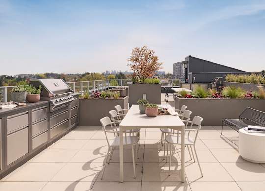 A patio with a table and chairs overlooking a cityscape.