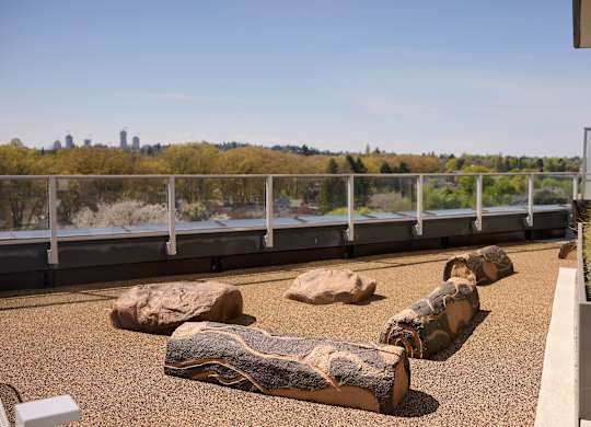 A balcony with a railing and a view of a city skyline.