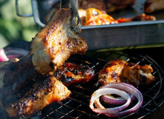 a grill with meat and onions on it